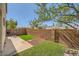 Well-maintained backyard featuring a grassy area and a brick wall providing added privacy at 3624 Snowy Pines St, Las Vegas, NV 89147