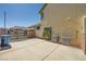Private paved backyard with easy access to external door, gated entrance, and air conditioning units at 3624 Snowy Pines St, Las Vegas, NV 89147