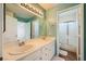 Bathroom with double sinks and large mirror reflecting the shower at 3624 Snowy Pines St, Las Vegas, NV 89147