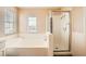 Bathroom featuring a separate tub and glass-enclosed shower at 3624 Snowy Pines St, Las Vegas, NV 89147