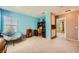 Bright bedroom features a workspace with blue walls, window, chair, and storage cabinets at 3624 Snowy Pines St, Las Vegas, NV 89147