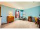 Bedroom featuring bright blue walls, carpet, two windows and accent furniture at 3624 Snowy Pines St, Las Vegas, NV 89147