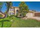 Inviting home featuring lush green lawn, mature trees, and a well-maintained exterior at 3624 Snowy Pines St, Las Vegas, NV 89147