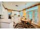 Cozy kitchen featuring granite countertops, white cabinetry, and a charming breakfast nook at 3624 Snowy Pines St, Las Vegas, NV 89147