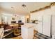 Well-lit kitchen with white cabinets, granite counters, flowing into the adjacent living room at 3624 Snowy Pines St, Las Vegas, NV 89147