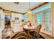 Charming kitchen with white cabinets, granite countertops, and a sunny breakfast area at 3624 Snowy Pines St, Las Vegas, NV 89147