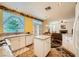 Open-concept kitchen with white cabinets, granite counters, and seamless access to the living area at 3624 Snowy Pines St, Las Vegas, NV 89147