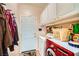 Functional laundry room with white cabinets, washer, dryer, and convenient hanging rack at 3624 Snowy Pines St, Las Vegas, NV 89147
