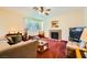 Cozy living room featuring a fireplace, comfortable seating, and large windows for natural light at 3624 Snowy Pines St, Las Vegas, NV 89147