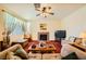 Spacious living room with a fireplace, comfortable seating, and ample natural light at 3624 Snowy Pines St, Las Vegas, NV 89147