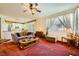Open-concept living area with a view of the kitchen, featuring a cozy sofa and natural light at 3624 Snowy Pines St, Las Vegas, NV 89147