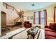 Inviting living room with staircase, plush seating, and carpet at 3624 Snowy Pines St, Las Vegas, NV 89147