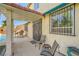 Covered patio with chairs, outdoor grill, and view of the refreshing pool and backyard at 3624 Snowy Pines St, Las Vegas, NV 89147