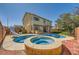 Outdoor oasis featuring a custom pool, spa, slide, and patio area at 3624 Snowy Pines St, Las Vegas, NV 89147