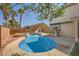 Inviting backyard pool with a slide, spa, mature landscaping, and an outdoor seating area provides ultimate relaxation at 3624 Snowy Pines St, Las Vegas, NV 89147