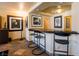 A stylish bar area with seating and modern artwork displayed on the walls at 3738 Amber Lantern Cir, Las Vegas, NV 89147