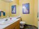 Half bathroom featuring a vanity with a sink and a decorative mirror and fixtures at 3738 Amber Lantern Cir, Las Vegas, NV 89147