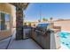 Outdoor grilling station offers a convenient way to entertain near the pool and covered patio at 3738 Amber Lantern Cir, Las Vegas, NV 89147