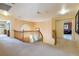 Hallway with wood railing and a view of the lower level atrium at 3738 Amber Lantern Cir, Las Vegas, NV 89147