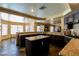 Spacious kitchen with granite counters, dark cabinetry, and plenty of natural light, perfect for cooking at 3738 Amber Lantern Cir, Las Vegas, NV 89147