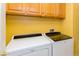 Bright laundry room with modern side-by-side washer and dryer units at 3738 Amber Lantern Cir, Las Vegas, NV 89147