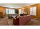 Carpeted living room featuring couches, shutters, and lamps at 3738 Amber Lantern Cir, Las Vegas, NV 89147