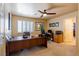 Well-lit office space with a large desk and comfortable seating at 3738 Amber Lantern Cir, Las Vegas, NV 89147