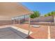 Landscaped backyard featuring a covered patio and terraced retaining wall at 3741 Cactus Wheel Ct, Las Vegas, NV 89129