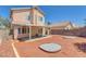 Spacious backyard featuring a covered patio, landscaped yard, and privacy fence under a bright blue sky at 3741 Cactus Wheel Ct, Las Vegas, NV 89129