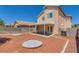 Backyard featuring a covered patio, landscaped yard, and block wall fence under a bright blue sky at 3741 Cactus Wheel Ct, Las Vegas, NV 89129