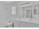 Bathroom with dual sinks, large mirror, and a shower-tub combo at 3741 Cactus Wheel Ct, Las Vegas, NV 89129