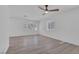 Spacious bedroom with a ceiling fan, wood-look flooring, and sunlit windows at 3741 Cactus Wheel Ct, Las Vegas, NV 89129