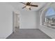 Bright bedroom with a ceiling fan and large window at 3741 Cactus Wheel Ct, Las Vegas, NV 89129