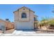 Two-story home with a two-car garage and manicured front yard landscaping at 3741 Cactus Wheel Ct, Las Vegas, NV 89129