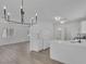 Open concept kitchen with stainless appliances, stone countertops, and modern lighting at 3741 Cactus Wheel Ct, Las Vegas, NV 89129