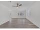 Bright living area with vinyl floors, a modern ceiling fan, and large windows at 3741 Cactus Wheel Ct, Las Vegas, NV 89129