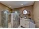 Bathroom featuring a frameless shower stall with decorative glass and tiled walls plus vanity with neutral color palette at 4045 N Chieftain St, Las Vegas, NV 89129