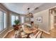 Bright dining area boasts wood floors, an oval table, and windows with plantation shutters at 4045 N Chieftain St, Las Vegas, NV 89129