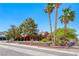 Inviting home with desert landscaping, palm trees, and unique red-colored walls at 4045 N Chieftain St, Las Vegas, NV 89129