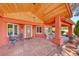 Covered front porch with a seating area and beautiful outdoor lighting at 4045 N Chieftain St, Las Vegas, NV 89129