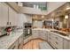 Gourmet kitchen featuring stainless steel appliances, granite countertops, and a breakfast bar at 4045 N Chieftain St, Las Vegas, NV 89129