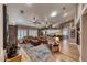 Inviting living room with hardwood floors, neutral walls, ceiling fan and multiple couches with access to open kitchen at 4045 N Chieftain St, Las Vegas, NV 89129