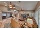 Inviting living room with hardwood floors, neutral walls, ceiling fan and a leather couch with decorative furnishings at 4045 N Chieftain St, Las Vegas, NV 89129