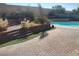 Multi-tiered backyard with brick patio, artifical turf, and a sparkling swimming pool at 424 Wright Way, Henderson, NV 89015