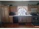 Traditional-style kitchen featuring modern appliances and a large window for natural light at 424 Wright Way, Henderson, NV 89015