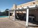 Outdoor seating area with a full grill, covered by a pergola next to a pool at 424 Wright Way, Henderson, NV 89015