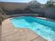 A sparkling pool with a textured concrete surround under a clear blue sky at 424 Wright Way, Henderson, NV 89015