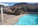 Backyard pool featuring cool blue waters with decorative retaining wall and mountain views at 424 Wright Way, Henderson, NV 89015