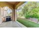 Covered patio featuring a built-in grill and artificial turf at 4636 Riva De Romanza St, Las Vegas, NV 89135