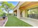 Beautiful backyard featuring a well-manicured lawn, fountain, and covered patio for relaxing and entertaining at 4636 Riva De Romanza St, Las Vegas, NV 89135